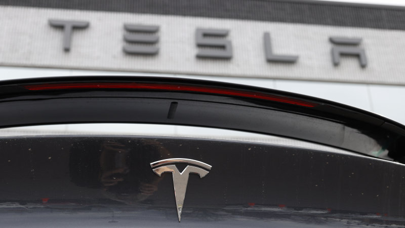 Tesla shares surge to another record high