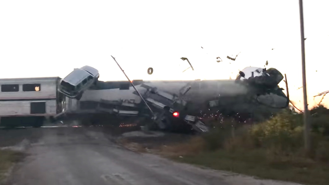 Watch vehicles go flying in terrifying train crash with car hauler